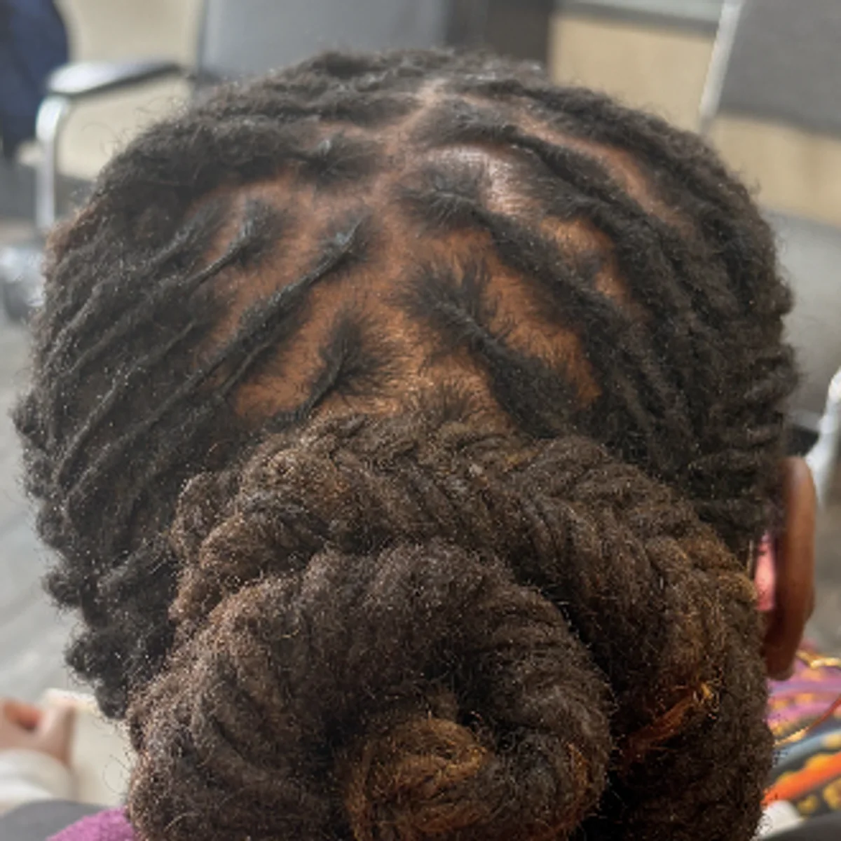 Original content — double loc bun with sculpted parting